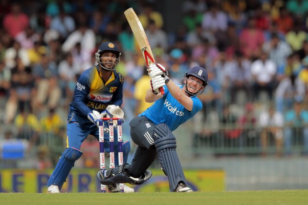 England's batsman Eoin Morgan plays a shot as Sri Lankan wicketkeeper Kumar Sangakkara watches during their fourth one-day international cricket match in Colombo, Sri Lanka, Sunday, Dec. 7, 2014. (AP Photo/Eranga Jayawardena)