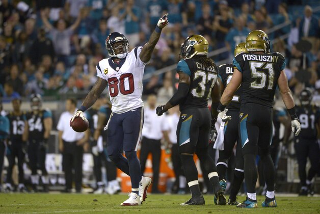 Houston Texans wide receiver Andre Johnson (80) gives the first down signal after catching a pass as Jacksonville Jaguars strong safety Johnathan Cyprien (37) and middle linebacker Paul Posluszny (51) watch during the second half of an NFL football game in Jacksonville, Fla., Thursday, Dec. 5, 2013.(AP Photo/Phelan M. Ebenhack)