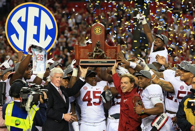 Dec 6, 2014; Atlanta, GA, USA; Alabama Crimson Tide head coach Nick Saban and his team celebrate with the trophy after the 2014 SEC Championship Game against the Missouri Tigers at the Georgia Dome. Alabama defeated Missouri 42-13. Mandatory Credit: Kevin Liles-USA TODAY Sports