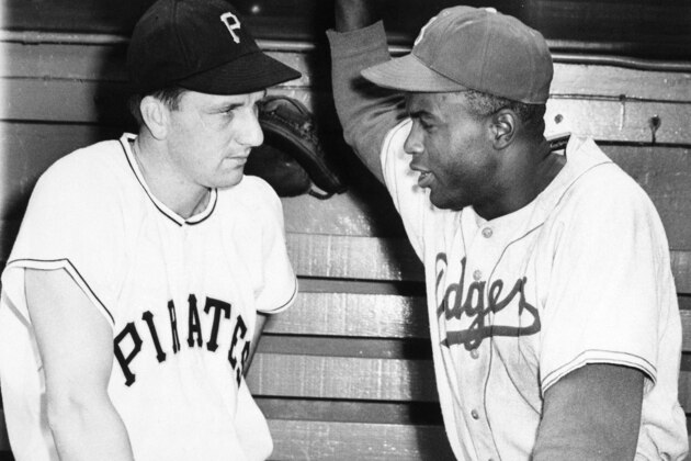 Ralph King, left, Pittsburgh Pirate outfielder, and Jackie Robinson, Brooklyn Dodger second baseman, get together at Pittsburgh, May 7, 1950, before their teams' scheduled game. (AP Photo)