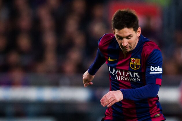 BARCELONA, SPAIN - DECEMBER 07: Lionel Messi of FC Barcelona is tackled by Salva Sevilla of RCD Espanyol during the La Liga match between FC Barcelona and RCD Espanyol at Camp Nou on December 7, 2014 in Barcelona, Spain. (Photo by Alex Caparros/Getty Images)