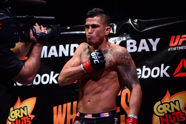 Dec 6, 2014; Las Vegas, NV, USA; Anthony Pettis (red) and Gilbert Melendez (blue) during UFC 181 at Madalay Bay Events Center. Pettis won via second round submission. Mandatory Credit: Joe Camporeale-USA TODAY Sports