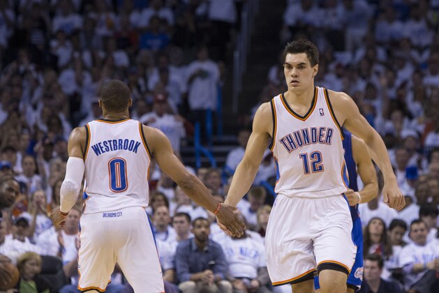 OKLAHOMA CITY, OK - May 13: Steven Adams #12 and Russell Westbrook #0 of the Oklahoma City Thunder celebrate in Game 5 of the Western Conference Semifinals against the Los Angeles Clippers during the 2014 NBA Playoffs at the Chesapeake Arena on May 13, 2014 in Oklahoma City, Oklahoma. NOTE TO USER:  User expressly acknowledges and agrees that, by downloading and/or using this photograph, user is consenting to the terms and conditions of the Getty Images License Agreement. Mandatory Copyright Notice:  Copyright 2014 NBAE (Photo by Richard Rowe/NBAE via Getty Images)