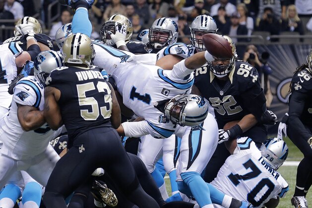 Carolina Panthers quarterback Cam Newton (1) dives over the pile for a touchdown in the first half of an NFL football game against the New Orleans Saints in New Orleans, Sunday, Dec. 7, 2014. (AP Photo/Bill Haber)