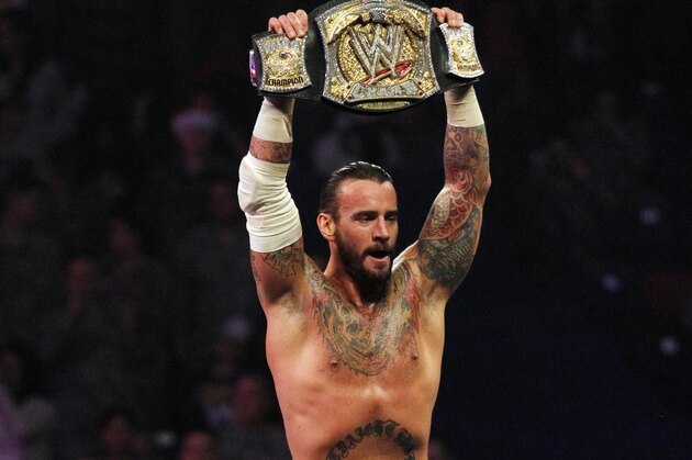In this Dec. 11, 2011 photo released by the WWE, WWE Champion CM Punk performs during WWE’s 9th annual