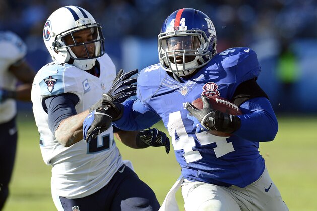 New York Giants running back Andre Williams (44) scores a touchdown against the Tennessee Titans on a 50-yard run in the second half of an NFL football game Sunday, Dec. 7, 2014, in Nashville, Tenn. At left is Tennessee Titans safety George Wilson (21). (AP Photo/Mark Zaleski)