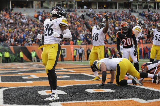 Pittsburgh Steelers running back Le'Veon Bell (26) reacts after scoring on a 13-yard touchdown run during the second half of an NFL football game against the Cincinnati Bengals Sunday, Dec. 7, 2014 in Cincinnati. (AP Photo/Michael Conroy)
