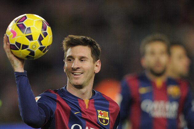 FC Barcelona's Lionel Messi, from Argentina, holds the ball after scoring a hat-trick in the Spanish La Liga soccer match between FC Barcelona and Espanyol at the Camp Nou stadium in Barcelona, Spain, Sunday, Dec. 7, 2014. (AP Photo/Manu Fernandez)