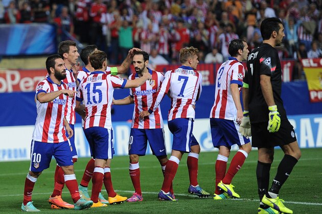 MADRID, SPAIN - OCTOBER 01:  Arda Turan (L) of Club Atletico de Madrid celebrates with teammates after scoring his team's opening goal during the UEFA Champions League Group A match between Club Atletico de Madrid and Juventus at Vicente Calderon Stadium on October 1, 2014 in Madrid, Spain.  (Photo by Denis Doyle/Getty Images)