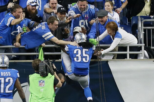 Detroit Lions running back Joique Bell (35) celebrates his touchdown with fans during the second half of an NFL football game against the Tampa Bay Buccaneers in Detroit, Sunday, Dec. 7, 2014. (AP Photo/Rick Osentoski)