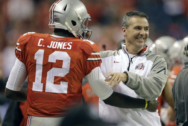 Ohio State head coach Urban Meyer, right, smiles along side quarterback Cardale Jones during the second half of the Big Ten Conference championship NCAA college football game against Wisconsin Saturday, Dec. 6, 2014, in Indianapolis. (AP Photo/Darron Cummings)