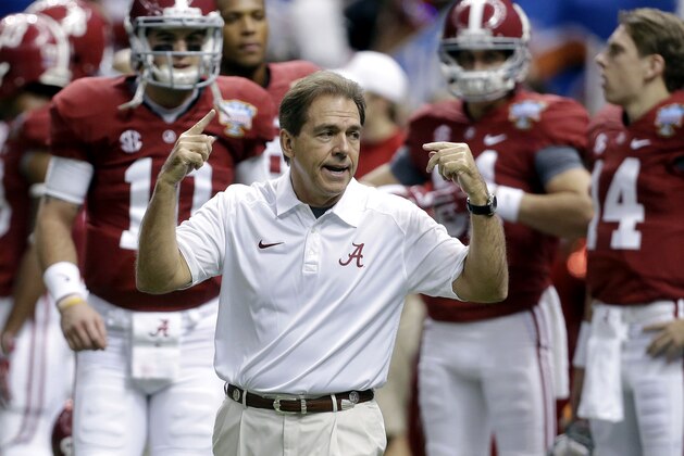FILE - In this file photo from Jan. 2, 2014, Alabama head coach Nick Saban, center, calls drills as his team warms up before the NCAA college football Sugar Bowl against Oklahoma in New Orleans. The Southeastern Conference is still reigning supreme on the recruiting trail. The Crimson Tide is poised to bring in another top-rated recruiting class on Wednesday's, Feb. 5, 2014, national signing day. Six SEC rivals also have built top 10 classes, according to the 247Sports composite rankings of the major recruiting sites. (AP Photo/Rusty Costanza, File)