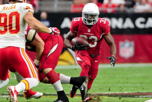 Dec 7, 2014; Glendale, AZ, USA; Arizona Cardinals running back Kerwynn Williams (33) carries the ball as Kansas City Chiefs inside linebacker Josh Mauga (90) defends during the first half at University of Phoenix Stadium. Mandatory Credit: Matt Kartozian-USA TODAY Sports