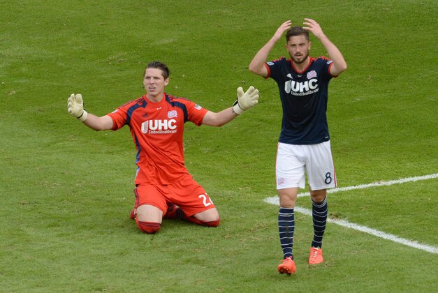 Dec 7, 2014; Los Angeles, CA, USA; New England Revolution goalkeeper Bobby Shuttleworth (22) and New England Revolution player Chris Tierney (8) react after a goal by Los Angeles Galaxy forward Robbie Keane (not pictured)  in overtime during the 2014 MLS Cup final at Stubhub Center. Mandatory Credit: Jayne Kamin-Oncea-USA TODAY Sports
