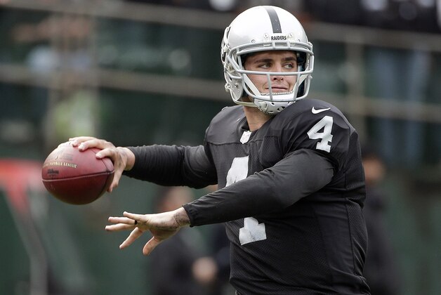 Oakland Raiders quarterback Derek Carr passes against the San Francisco 49ers during the first quarter of an NFL football game in Oakland, Calif., Sunday, Dec. 7, 2014. (AP Photo/Marcio Jose Sanchez)