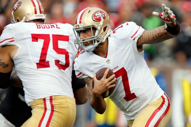 OAKLAND, CA - DECEMBER 07:  Colin Kaepernick #7 of the San Francisco 49ers scrambles in the second quarter behind Alex Boone #75 of the San Francisco 49ers against the Oakland Raiders at O.co Coliseum on December 7, 2014 in Oakland, California.  (Photo by Brian Bahr/Getty Images)