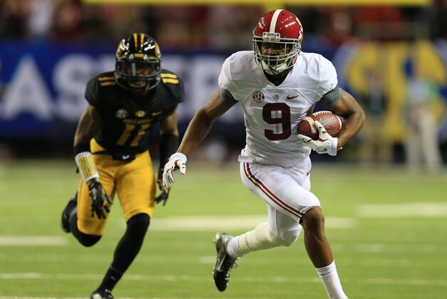 Dec 6, 2014; Atlanta, GA, USA; Alabama Crimson Tide wide receiver Amari Cooper (9) runs the ball past Missouri Tigers defensive back Aarion Penton (11) during the first quarter of the 2014 SEC Championship Game at the Georgia Dome. Mandatory Credit: Kevin Liles-USA TODAY Sports