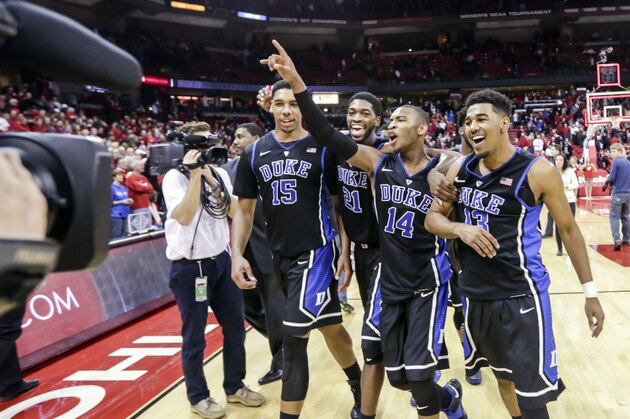 Duke's Jahlil Okafor (15), Amile Jefferson (21), Rasheed Sulaimon (14) and Matt Jones all celebrate after Duke beat Wisconsin 80-70 in an NCAA college basketball game Wednesday, Dec. 3, 2014, in Madison, Wis. (AP Photo/Andy Manis)