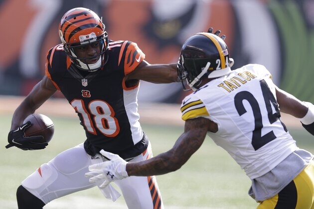 Cincinnati Bengals wide receiver A.J. Green (18) runs against Pittsburgh Steelers cornerback Ike Taylor (24) during the first half of an NFL football game Sunday, Dec. 7, 2014 in Cincinnati. (AP Photo/Michael Conroy)