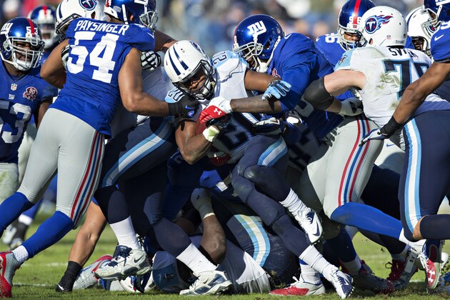 NASHVILLE, TN - DECEMBER 7:  Bishop Sankey #20 of the Tennessee Titans runs the ball and is tackled by Jason Pierre-Paul #90 of the New York Giants at LP Field on December 7, 2014 in Nashville, Tennessee.  The Giants defeated the Titans 36-7.  (Photo by Wesley Hitt/Getty Images)