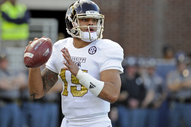 Mississippi State quarterback Dak Prescott (15) looks to pass during the first half of an NCAA college football game against Mississippi in Oxford, Miss., Saturday, Nov. 29, 2014. (AP Photo/Thomas Graning)
