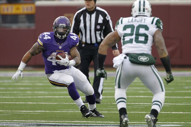 Minnesota Vikings running back Matt Asiata, left, runs from New York Jets strong safety Dawan Landry during the second half of an NFL football game, Sunday, Dec. 7, 2014, in Minneapolis. (AP Photo/Ann Heisenfelt)