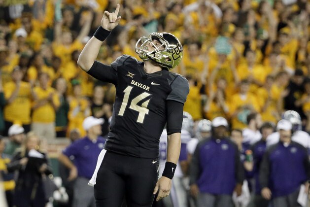 Baylor quarterback Bryce Petty (14) points skyward after a running score by running back Shock Linwood in the first half of an NCAA college football game against Kansas State, Saturday, Dec. 6, 2014, in Waco, Texas. (AP Photo/Tony Gutierrez)