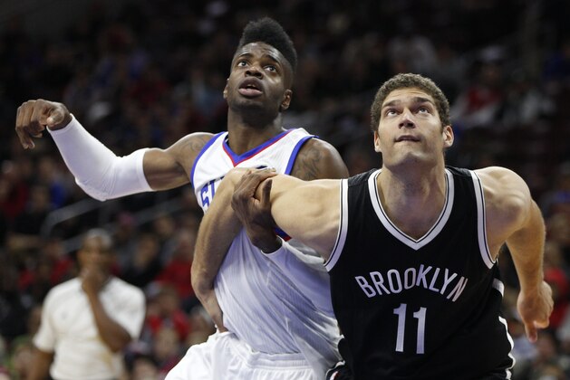 Brooklyn Nets' Brook Lopez, right, blocks out, Philadelphia 76ers' Nerlens Noel, left, during the second half of an NBA basketball game, Wednesday, Nov. 26, 2014, in Philadelphia. The Nets won 99-91. (AP Photo/Chris Szagola)