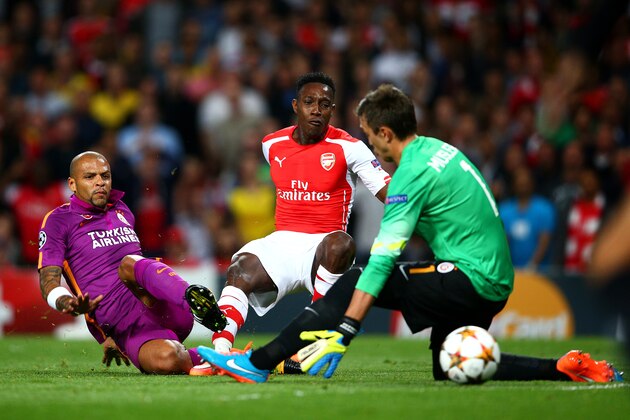 LONDON, ENGLAND - OCTOBER 01:  Danny Welbeck of Arsenal scores the opening goal past Fernando Muslera of Galatasaray AS during the UEFA Champions League group D match between Arsenal FC and Galatasaray AS at Emirates Stadium on October 1, 2014 in London, United Kingdom.  (Photo by Paul Gilham/Getty Images)