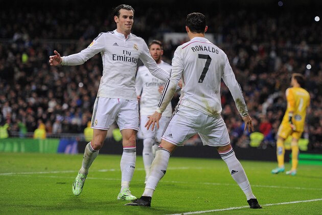 MADRID, SPAIN - DECEMBER 06:  Cristiano Ronaldo of Real Madrid celebrates with Gareth Bale after scoring Real's opening goal during the La Liga match between Real Madrid CF and Celta Vigo at Estadio Santiago Bernabeu on December 6, 2014 in Madrid, Spain.  (Photo by Denis Doyle/Getty Images)