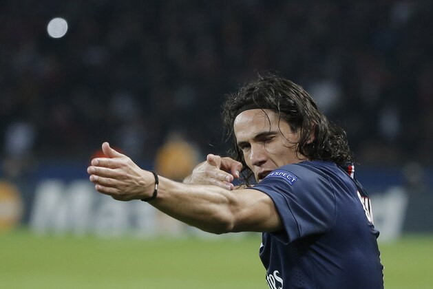 PSG's Edinson Cavani celebrates his opening goal during the Champions League Group F soccer match between Paris Saint Germain and Ajax at Parc des Princes stadium in Paris, France, Tuesday, Nov. 25, 2014. (AP Photo/Francois Mori)