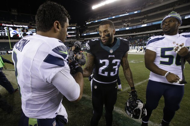 Seattle Seahawks' Russell Wilson, left, and Philadelphia Eagles' Nolan Carroll meet after an NFL football game, Sunday, Dec. 7, 2014, in Philadelphia. Seattle won 24-14. (AP Photo/Matt Rourke)