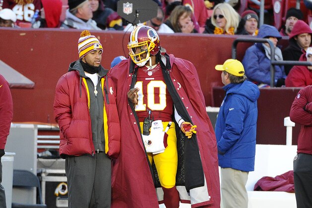 Dec 7, 2014; Landover, MD, USA; Washington Redskins quarterback Robert Griffin III (10) on the sidelines against the St. Louis Rams during the second half at FedEx Field. Mandatory Credit: Brad Mills-USA TODAY Sports