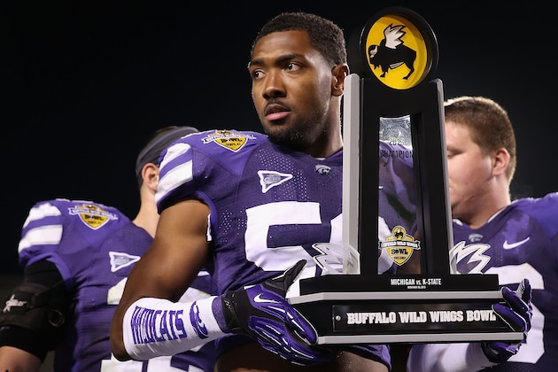 TEMPE, AZ - DECEMBER 28:  Linebacker Blake Slaughter #53 of the Kansas State Wildcats celebrates with the Buffalo Wild Wings Bowl trophy after defeating the Michigan Wolverines at Sun Devil Stadium on December 28, 2013 in Tempe, Arizona.  The Wildcats defeated the Wolverines 31-14.  (Photo by Christian Petersen/Getty Images)