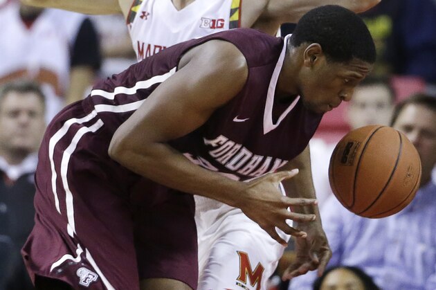 Fordham forward Ryan Rhoomes, front, tries to maintain possession as he collides with Maryland's Jake Layman while driving to the basket during the second half of an NCAA college basketball game, Thursday, Nov. 20, 2014, in College Park, Md. Maryland won 66-50. (AP Photo/Patrick Semansky)