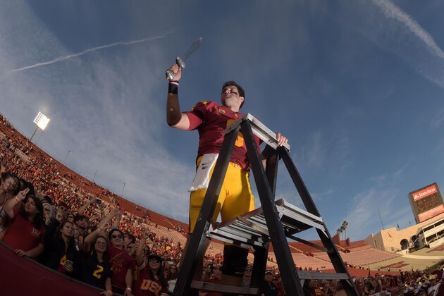 Nov 29, 2014; Los Angeles, CA, USA; Southern California Trojans quarterback Cody Kessler (6) conducts the Spirit of Troy marching band after the game against the Notre Dame Fighting Irish at Los Angeles Memorial Coliseum. USC defeated Notre Dame 49-14.  Mandatory Credit: Kirby Lee-USA TODAY Sports