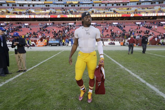 Washington Redskins quarterback Robert Griffin III (10) walks across the field with his jersey after an NFL football game against the St. Louis Rams in Landover, Md., Sunday, Dec. 7, 2014. The Rams defeated the Redskins 24-0. (AP Photo/Patrick Semansky)