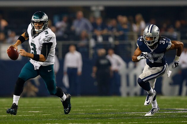 ARLINGTON, TX - NOVEMBER 27:  Mark Sanchez #3 of the Philadelphia Eagles scrambles from the pocket as C.J. Spillman #37 of the Dallas Cowboys gives chase in the second half at AT&T Stadium on November 27, 2014 in Arlington, Texas.  (Photo by Tom Pennington/Getty Images)