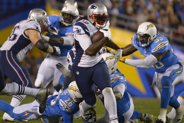 Dec 7, 2014; San Diego, CA, USA; New England Patriots running back LeGarrette Blount (29) runs through the San Diego Chargers defense during the second quarter at Qualcomm Stadium. Mandatory Credit: Robert Hanashiro-USA TODAY Sports