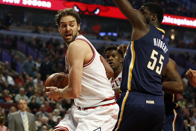 Chicago Bulls forward Pau Gasol, left, drives past Indiana Pacers center Roy Hibbert (55) during the first half of an NBA basketball game on Saturday, Nov. 15, 2014, in Chicago. (AP Photo/Andrew A. Nelles)