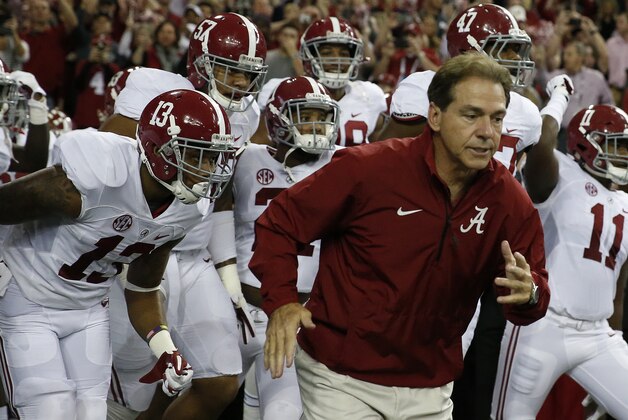 Alabama head coach Nick Saban takes the field with his team before the first half of the Southeastern Conference championship NCAA college football game against Missouri, Saturday, Dec. 6, 2014, in Atlanta. (AP Photo/Brynn Anderson)