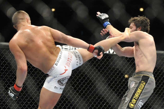 Jan 25, 2014; Chicago, IL, USA; Daron Cruickshank (red gloves) fights Mike Rio (blue gloves) during UFC on FOX 10 at the United Center. Mandatory Credit: David Banks-USA TODAY Sports