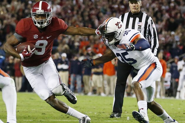 Alabama wide receiver Amari Cooper (9) moves against Auburn defensive back Joe Turner (35) during the second half of the Iron Bowl NCAA college football game, Saturday, Nov. 29, 2014, in Tuscaloosa, Ala. (AP Photo/Brynn Anderson)