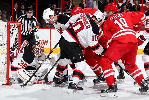 RALEIGH, NC - DECEMBER 08: Cory Schneider #35 of the New Jersey Devils makes a save through traffic in front of the net during their NHL game against the Carolina Hurricanes at PNC Arena on December 8, 2014 in Raleigh, North Carolina.  (Photo by Gregg Forwerck/NHLI via Getty Images)