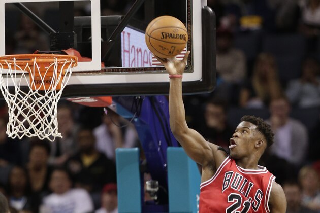 Chicago Bulls' Jimmy Butler (21) goes to the basket against the Charlotte Hornets during the first half of an NBA basketball game in Charlotte, N.C., Wednesday, Dec. 3, 2014. (AP Photo/Chuck Burton)