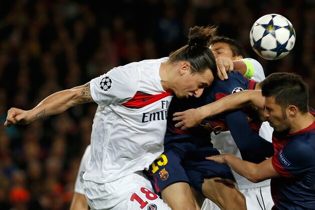 PSG's Zlatan Ibrahimovic, from Sweden, left, jumps for a header during the Champions League quarterfinal second leg soccer match between FC Barcelona and Paris Saint-Germain FC at the Camp Nou stadium in Barcelona, Spain, Wednesday, April 10, 2013. (AP Photo/Emilio Morenatti)
