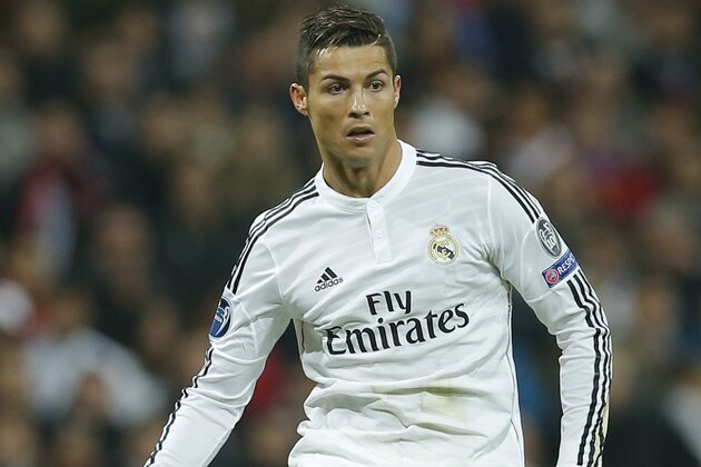 Real Madrid's Cristiano Ronaldo runs with the ball during a Group B Champions League soccer match between Real Madrid and Liverpool at the Santiago Bernabeu stadium in Madrid, Spain, Tuesday Nov. 4, 2014. (AP Photo/Paul White)