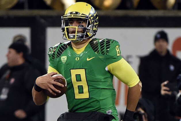 CORVALLIS, OR - NOVEMBER 29: Quarterback Marcus Mariota #8 of the Oregon Ducks scores a touchdown during the third quarter of the game against the Oregon State Beavers at Reser Stadium on November 29, 2014 in Corvallis, Oregon. (Photo by Steve Dykes/Getty Images)