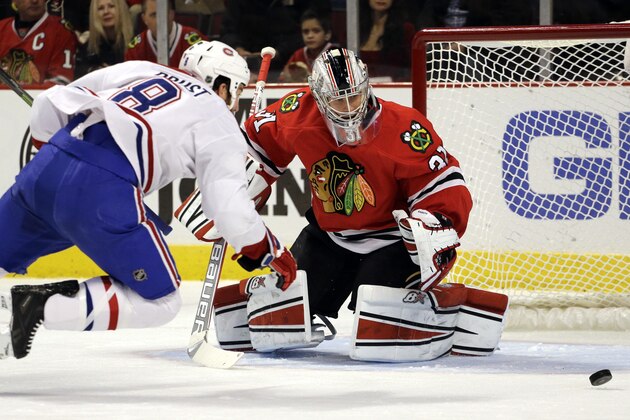 Chicago Blackhawks goalie Antti Raanta (31) blocks a shot by Montreal Canadiens left wing Brandon Prust (8) during the first period of an NHL hockey game in Chicago, Friday, Dec. 5, 2014. (AP Photo/Nam Y. Huh)