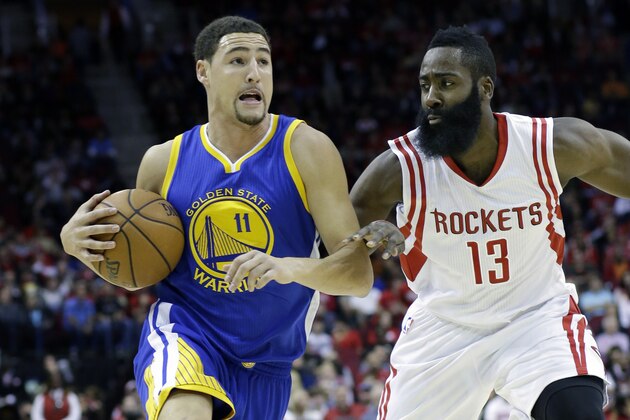 Golden State Warriors' Klay Thompson (11) is pursued by Houston Rockets' James Harden (13) in the first half of an NBA basketball game Saturday, Nov. 8, 2014, in Houston. (AP Photo/Pat Sullivan)